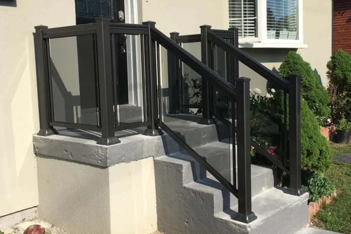Black aluminum framed grey tinted glass railing in Pickering