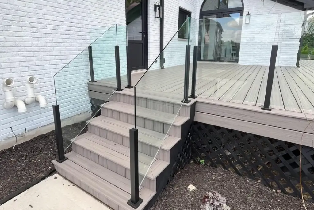 Semi-frameless glass stair railing with aluminum posts on an East York porch