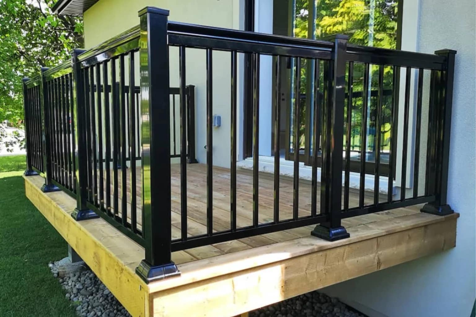 Black aluminum picket railing on a wood deck in Markham